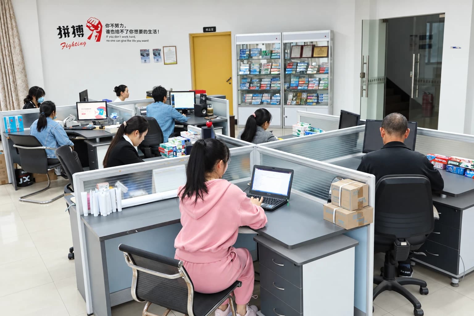 Airsun team members working at desks with oral care product samples in the office.