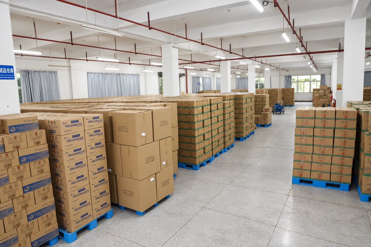 Finished goods in cartons stacked on blue pallets in the Airsun warehouse.