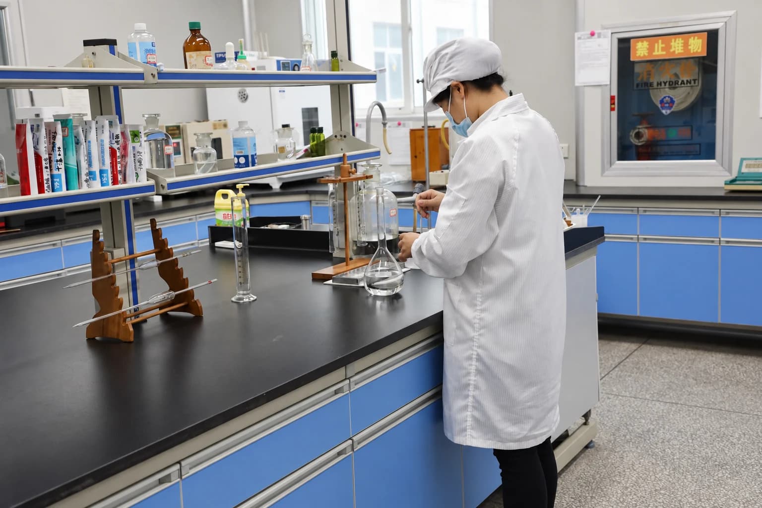 A technician working with glassware and oral care samples in the Airsun laboratory.