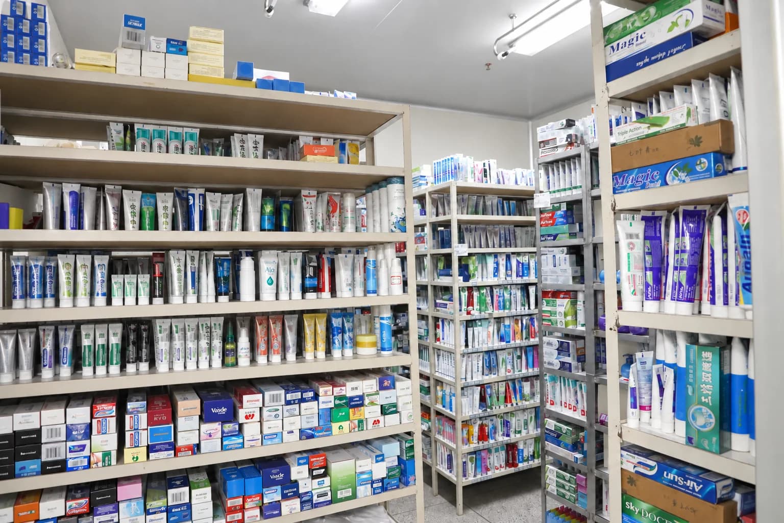 Shelves of toothpaste samples and packaging in Airsun's sample room, with sample arrangement digitally tidied.