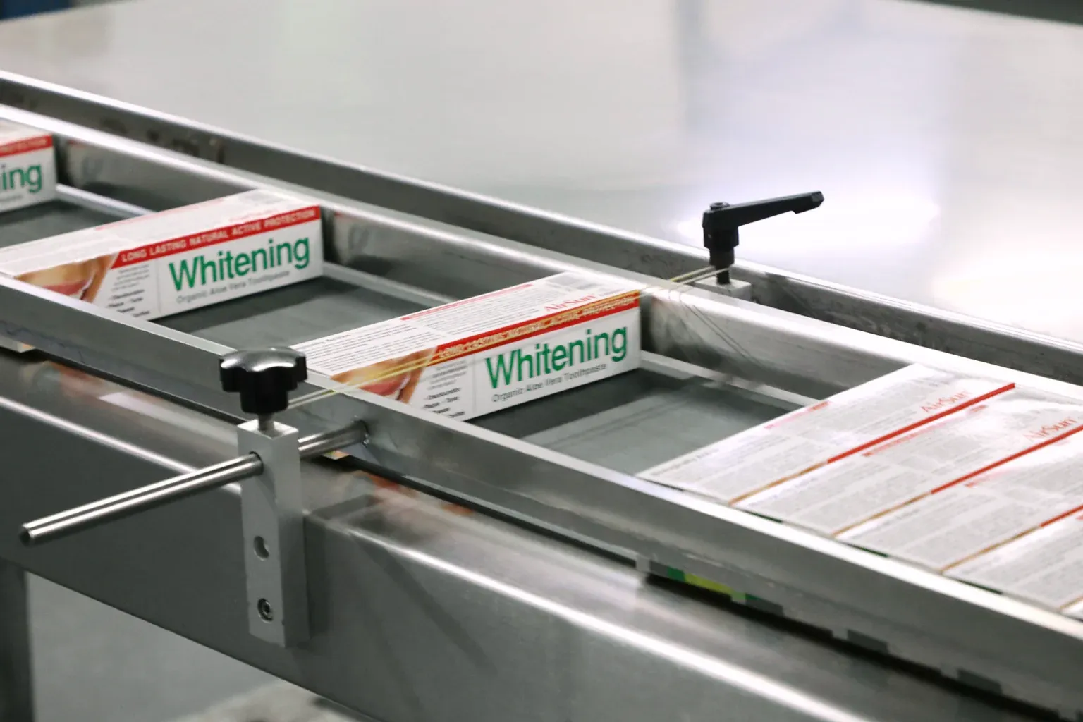 Toothpaste cartons on a packaging conveyor